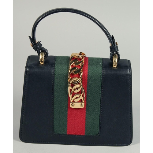 1547 - A GOOD GUCCI SMALL CLUTCH BAG 7.5ins x 5.5ins with gilt Gucci lock and leather handles.