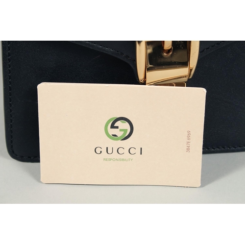 1547 - A GOOD GUCCI SMALL CLUTCH BAG 7.5ins x 5.5ins with gilt Gucci lock and leather handles.