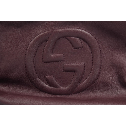 1551 - A LARGE GUCCI MAROON LEATHER SOFT BAG, 'G' on the side. 18ins x 12 ins with two leather handles.