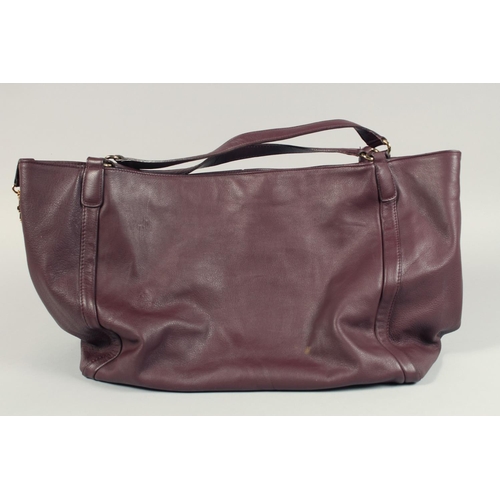 1551 - A LARGE GUCCI MAROON LEATHER SOFT BAG, 'G' on the side. 18ins x 12 ins with two leather handles.