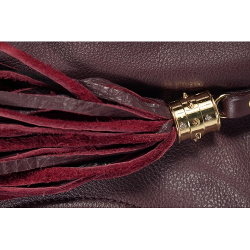 1551 - A LARGE GUCCI MAROON LEATHER SOFT BAG, 'G' on the side. 18ins x 12 ins with two leather handles.