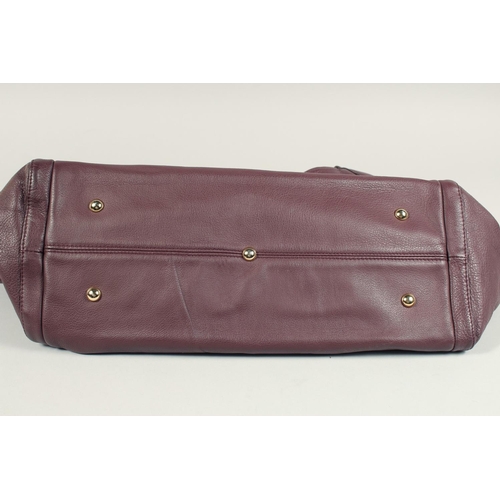 1551 - A LARGE GUCCI MAROON LEATHER SOFT BAG, 'G' on the side. 18ins x 12 ins with two leather handles.