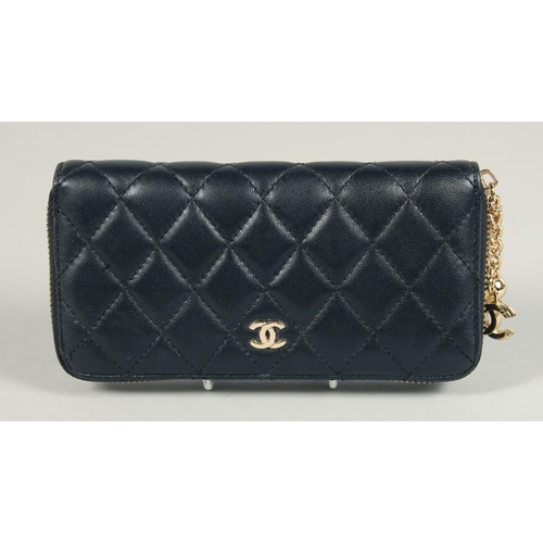 1552 - A CHANEL PADDED LEATHER PURSE, No. 10218184, with a gilt hinge. 7.5ins x 3.5ins.