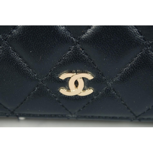 1552 - A CHANEL PADDED LEATHER PURSE, No. 10218184, with a gilt hinge. 7.5ins x 3.5ins.