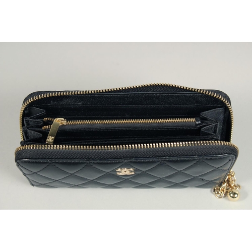 1552 - A CHANEL PADDED LEATHER PURSE, No. 10218184, with a gilt hinge. 7.5ins x 3.5ins.