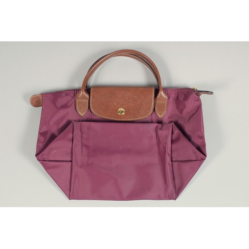 1553 - A LONGCHAMP FOLDING TOTE BAG. 7ins x 3.5 with two handles.