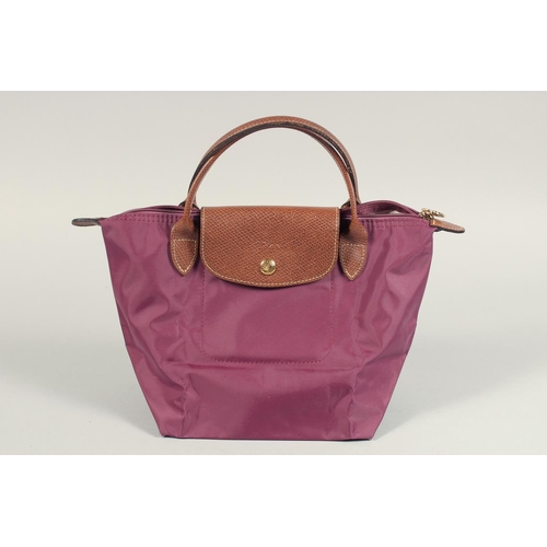 1553 - A LONGCHAMP FOLDING TOTE BAG. 7ins x 3.5 with two handles.