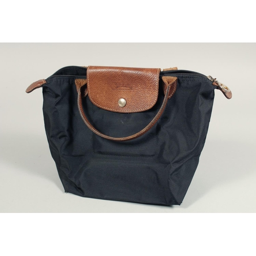 1555 - A LONGCHAMP FOLDING TOTE BAG. 7ins x 3.5 with two handles.