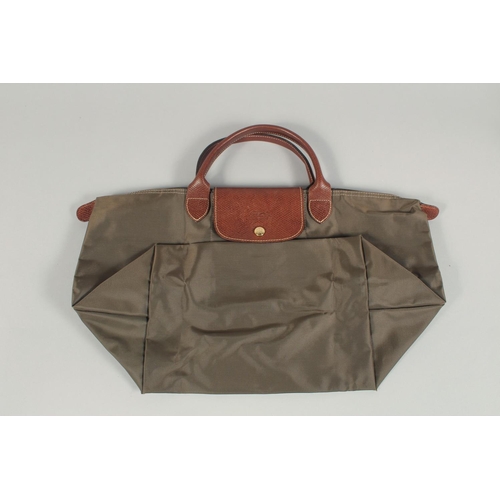 1557 - A LONGCHAMP FOLDING TOTE BAG. 8ins x.5ins with two handles.