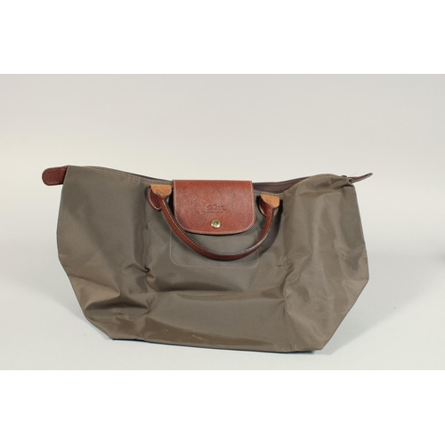 1557 - A LONGCHAMP FOLDING TOTE BAG. 8ins x.5ins with two handles.