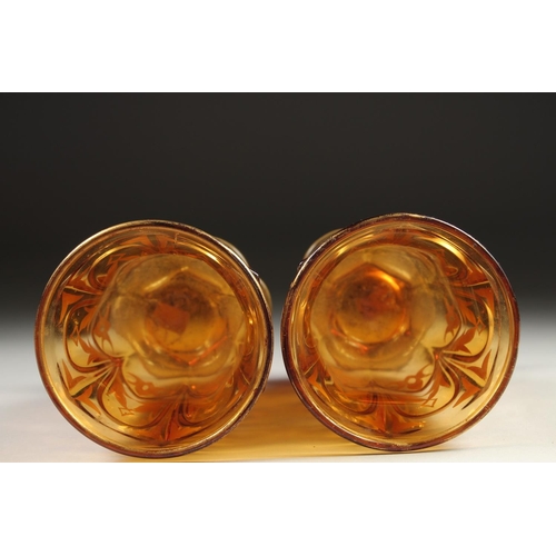 1080 - A PAIR OF AMBER TINTED BEYKOS BEAKERS. 4.75ins