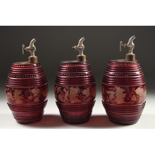 1082 - A SET OF THREE BOHEMIAN RUBY GLASS BARRELS engraved with deer and dogs, with chrome tops.