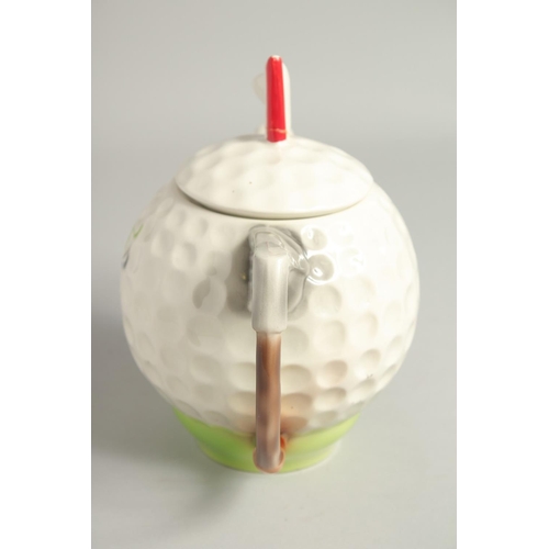 1136 - A TONY WOOD GOLF BALL TEA POT AND COVER. 8ins high.