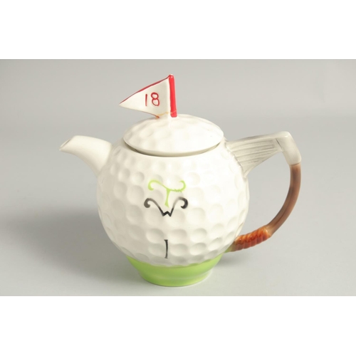 1136 - A TONY WOOD GOLF BALL TEA POT AND COVER. 8ins high.