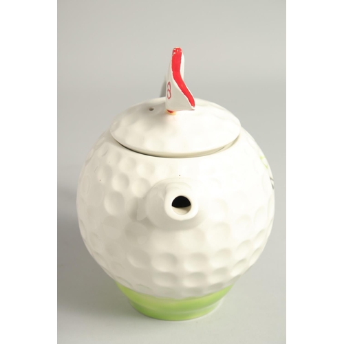 1136 - A TONY WOOD GOLF BALL TEA POT AND COVER. 8ins high.