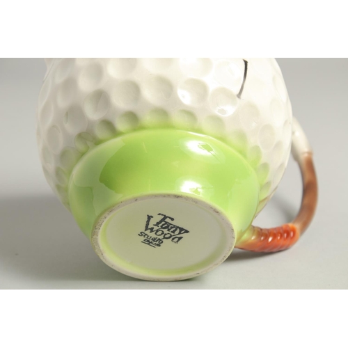 1136 - A TONY WOOD GOLF BALL TEA POT AND COVER. 8ins high.