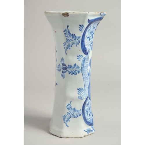 1169 - A DUTCH BLUE AND WHITE TIN GLAZE VASE with figures in a landscape. 9ins high.