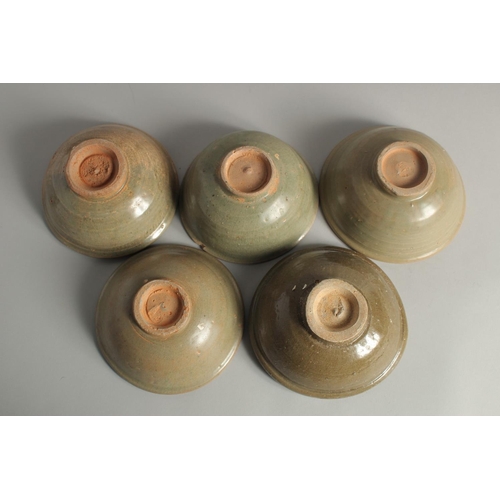 1179 - FIVE VARIOUS CELADON GLAZED BOWLS. 5.5ins diameter.