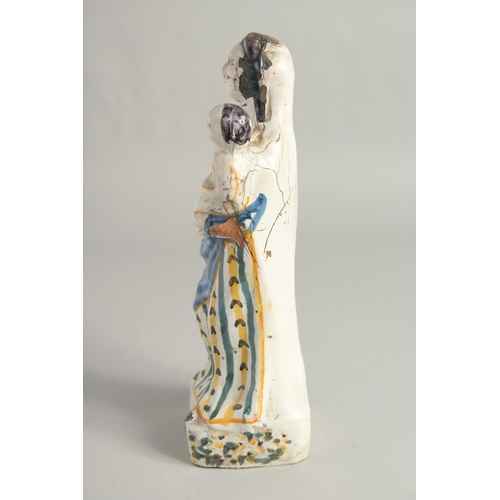 1184 - AN 18TH CENTURY FIANCE POTTERY FIGURE, Madonna and child. 12ins high.