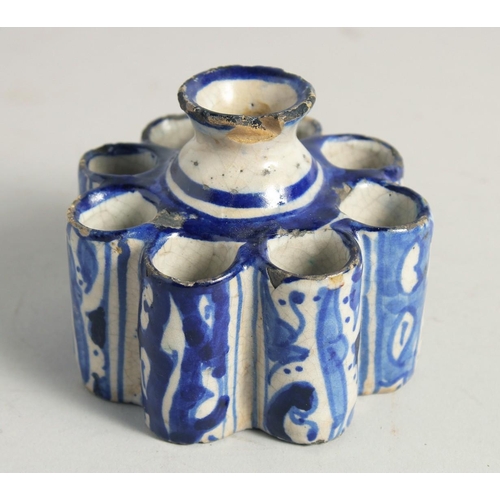 1187 - AN EARLY ISLAMIC POTTERY EIGHT DIVISION INKWELL. 3.5ins diameter.