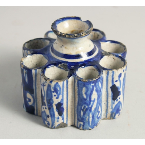 1187 - AN EARLY ISLAMIC POTTERY EIGHT DIVISION INKWELL. 3.5ins diameter.