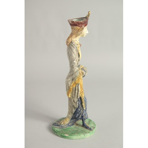 1193 - A MAJOLICA POTTERY CANDLESTICK FIGURE. 11ins high.