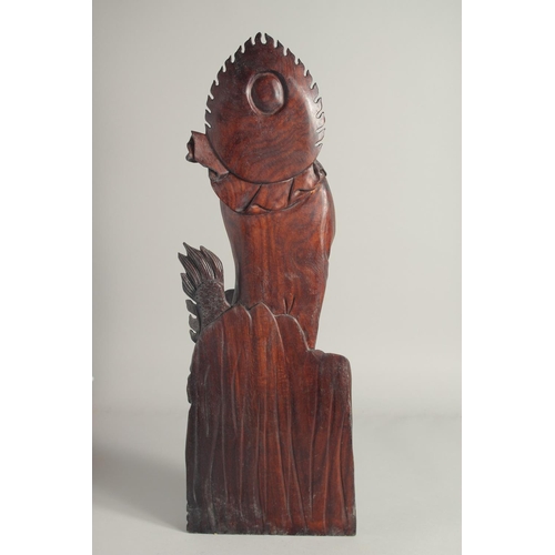 1212 - A CHINESE CARVED ROSEWOOD FIGURE. 1ft 11ins long.