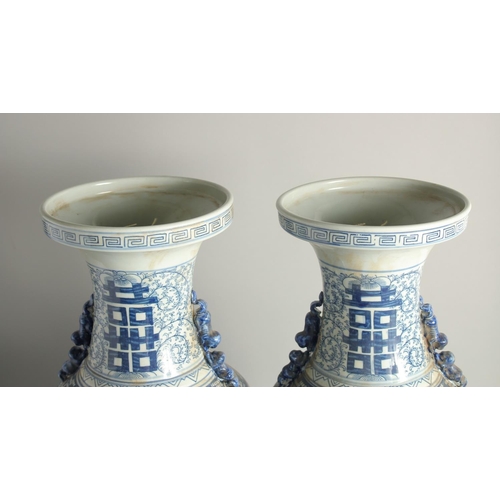 1215 - A TALL, PAIR OF CHINESE BLUE AND WHITE VASES. 1ft 11ins high.