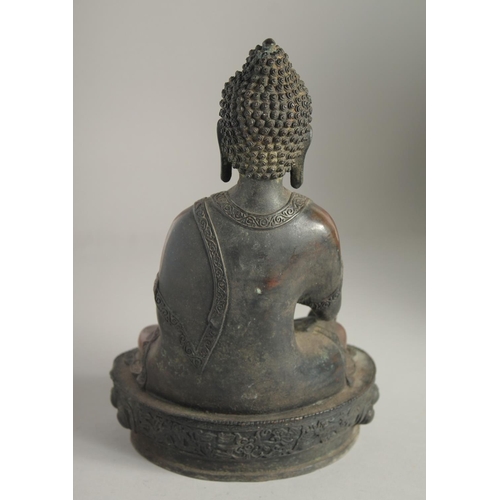 1216 - A BRONZE SEATED BUDDHA. 12ins high.