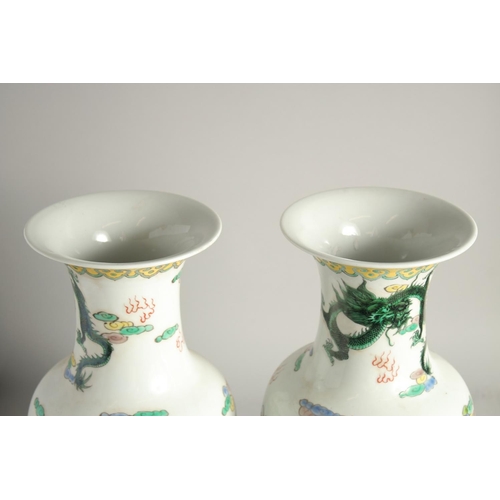 1217 - A PAIR OF CHINESE PORCELAIN VASES painted with people. 1ft 5ins high.