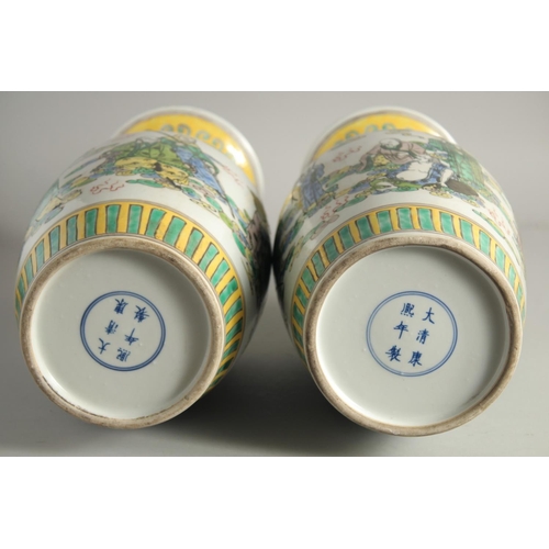 1217 - A PAIR OF CHINESE PORCELAIN VASES painted with people. 1ft 5ins high.