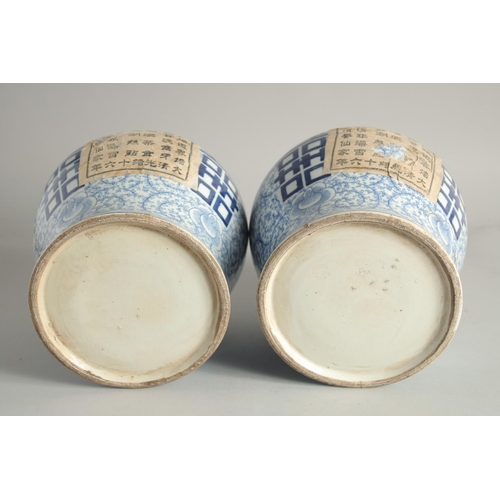 1220 - A PAIR OF CHINESE BLUE AND WHITE GINGER JARS AND COVERS. 12ins high.