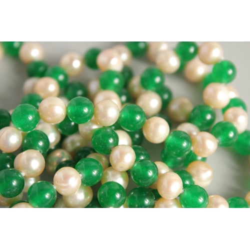 1226 - A STRING OF JADE AND PEARL BEADS. 48ins long.