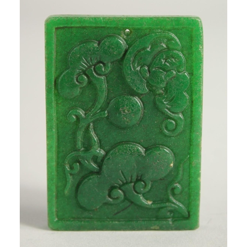 1228 - A CHINESE CARVED DRAGON JADE PENDANT. 2ins