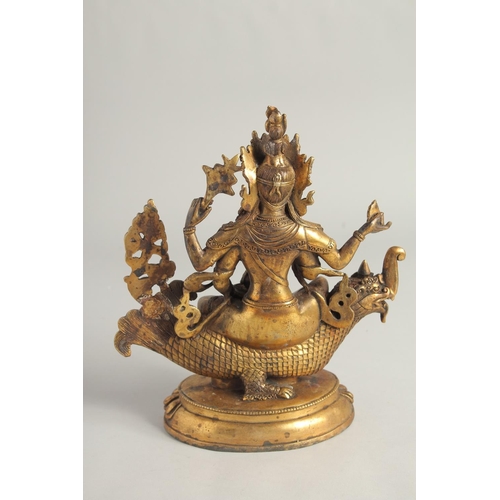 1237 - A CHINESE GILT BRONZE GOD seated on a dragon. 10ins high.