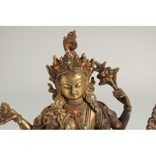 1237 - A CHINESE GILT BRONZE GOD seated on a dragon. 10ins high.