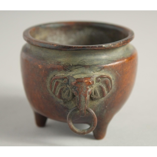 1240 - A SMALL CHINESE BRONZE CIRCULAR CENSER with elephant handles. 2.25ins diameter.