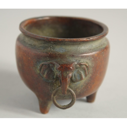 1240 - A SMALL CHINESE BRONZE CIRCULAR CENSER with elephant handles. 2.25ins diameter.