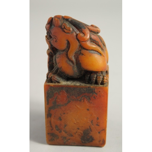 1245 - A CHINESE CARVED SOAPSTONE DRAGON SEAL. 4ins high.