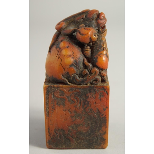 1245 - A CHINESE CARVED SOAPSTONE DRAGON SEAL. 4ins high.