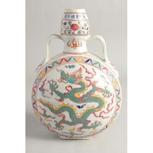 1253 - A CHINESE WUCAI PORCELAIN TWIN HANDLED MOON FLASK decorated with a central dragon. 29cm high.