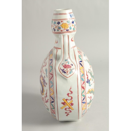 1253 - A CHINESE WUCAI PORCELAIN TWIN HANDLED MOON FLASK decorated with a central dragon. 29cm high.