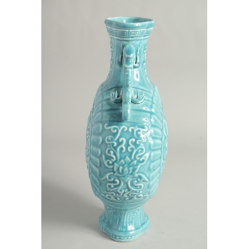 1256 - A CHINESE BLUE GLAZE TWIN HANDLED MOON FLASK with a central relief dragon motif. 33cm high.