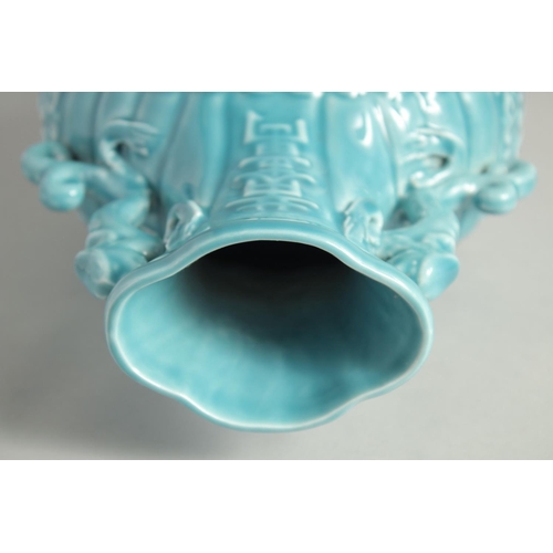 1256 - A CHINESE BLUE GLAZE TWIN HANDLED MOON FLASK with a central relief dragon motif. 33cm high.