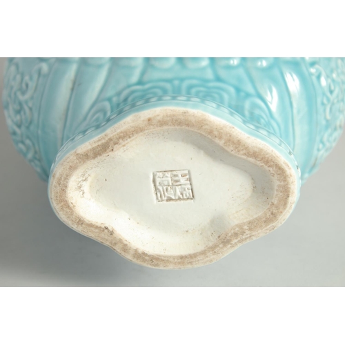 1256 - A CHINESE BLUE GLAZE TWIN HANDLED MOON FLASK with a central relief dragon motif. 33cm high.