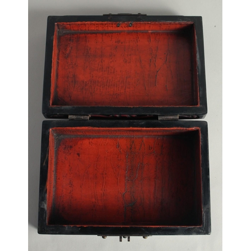 1259 - A CHINESE LACQUERED WOOD RECTANGULAR BOX with carved decoration and hinged lid. 21cm x 14cm