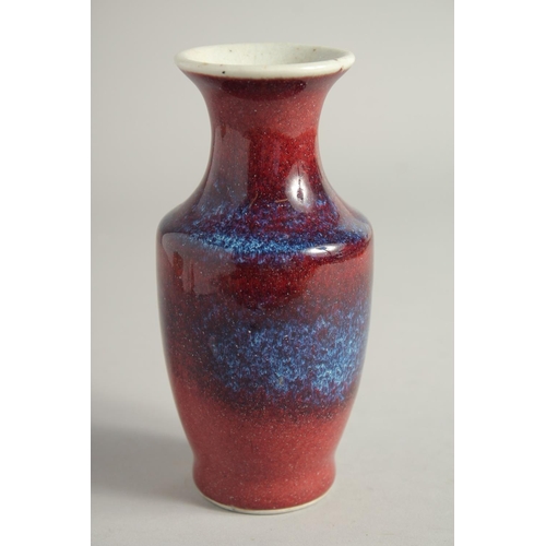 1261 - A SMALL FLAMBE STYLE GLAZE PORCELAIN VASE. 15.5cm high.