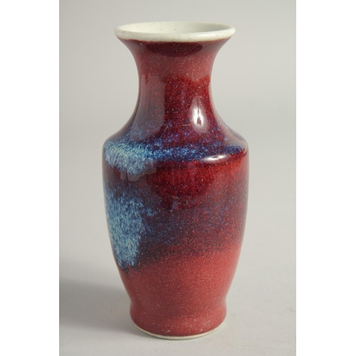 1261 - A SMALL FLAMBE STYLE GLAZE PORCELAIN VASE. 15.5cm high.