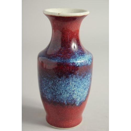 1261 - A SMALL FLAMBE STYLE GLAZE PORCELAIN VASE. 15.5cm high.