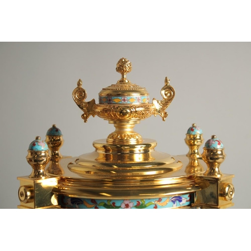 1282 - A GOOD GILT METAL AND CLOISONNE ENAMEL CIRCULAR COLUMN CLOCK with urn finial. 1ft 6ins high.